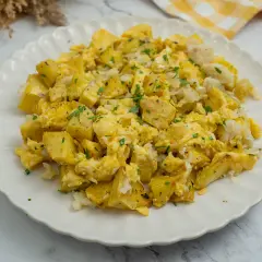 Un delicioso revuelto de bacalao con patatas, espolvoreado con perejil fresco. Un plato casero perfecto para cualquier momento del día.