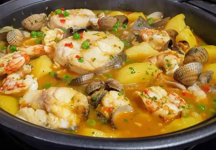 Merluza a la cazuela con patatas, gambas y berberechos, un plato marinero reconfortante y lleno de sabor.