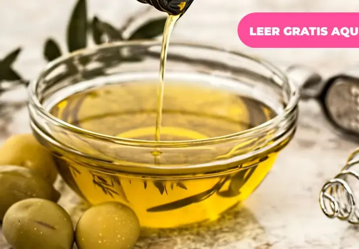 Aceite de oliva vertiéndose en un cuenco, rodeado de aceitunas y hojas de olivo. Descubre los múltiples usos del olivo.