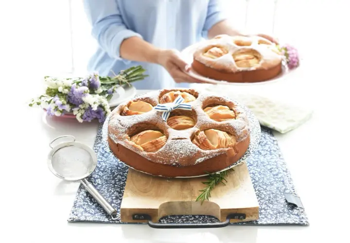 Deliciosa tarta de manzana Thermomix, espolvoreada con azúcar glas y decorada con un lazo azul.