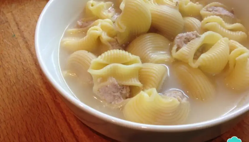 Un tazón de sopa de galets, con pasta grande rellena de carne picada en un caldo sabroso.