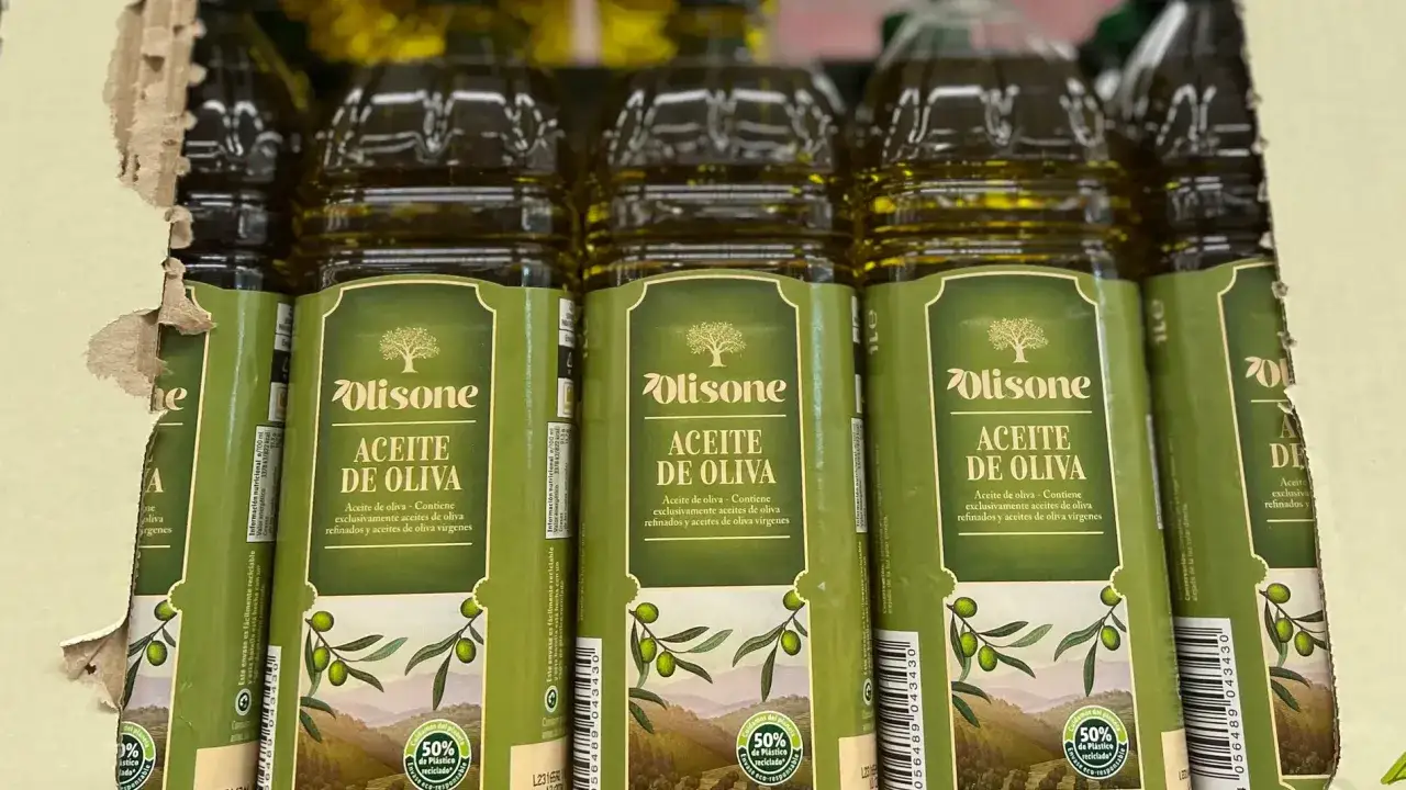 Botellas de aceite de oliva Olisone en fila, con etiquetas verdes que muestran olivos y el texto 